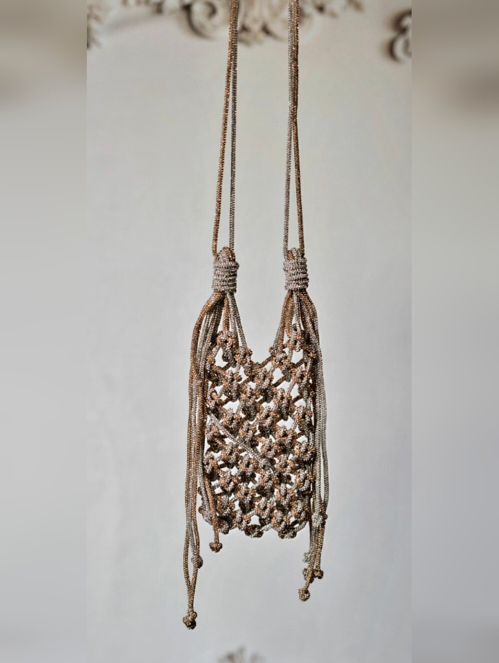  Ornate, handcrafted phone bag In two-tone.